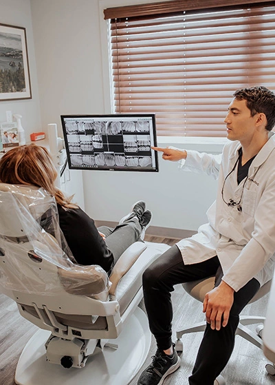 Dr. Kanellis showing a patient her dental x-rays
