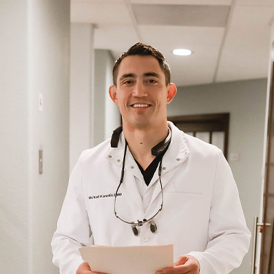 Sparks, NV dentist Dr. Kanellis standing inside the office hallway.